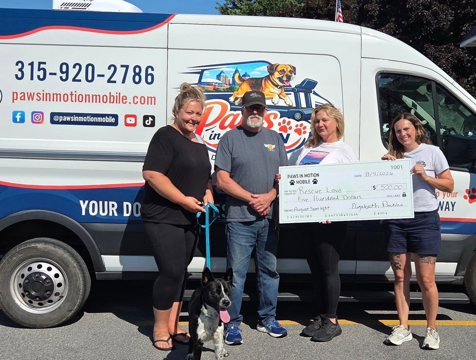 Liz presenting a $500 check to RescueLove